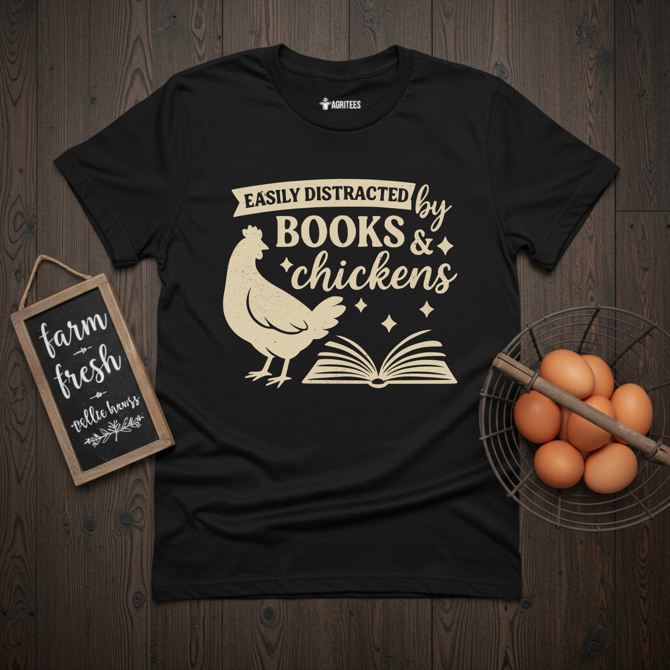 Easily Distracted by Books and Chickens t-shirt featuring vintage-style cream illustration of chicken and open book on navy background, perfect gift for reading enthusiasts who also love backyard poultry keeping.