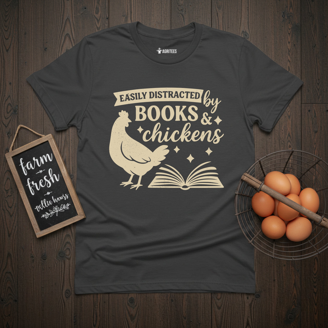 Vintage-style t-shirt design featuring a chicken and open book with 'Easily Distracted by Books & Chickens' text on grey fabric - perfect for literary enthusiasts who also love raising backyard poultry.
