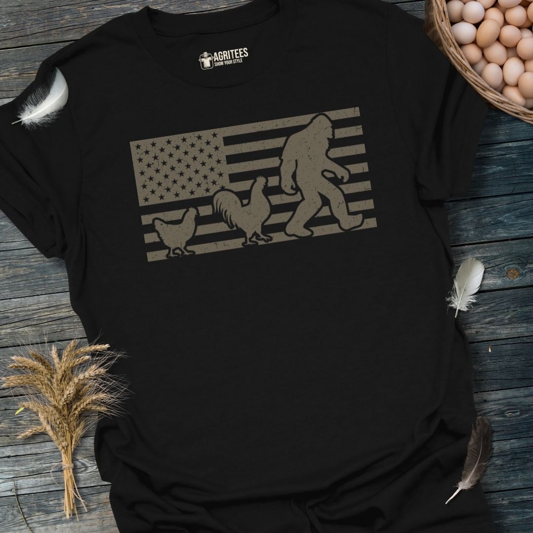 Chicken Following Bigfoot. Funny Sasquatch USA Flag T-Shirt